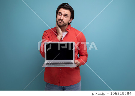 smart european young guy with chic black hair shows promotional offer on blank screen 106219594