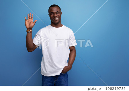 nice young african guy in white t-shirt waving his hand 106219783