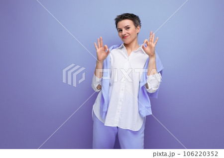 portrait of casual young brunette woman with short haircut in white shirt pointing finger portrait of casual young brunette woman with short haircut in white shirt pointing finger 106220352
