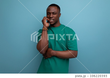 young excited american man in t-shirt on blue background with copy space. people lifesal concept 106220393