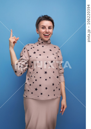 pretty young european woman with short dark hair in a casual suit with a skirt 106220394