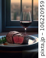 Beef meat steak on white and glass of red wine on table near window at evening Beef meat steak on white and glass of red wine on table near window at evening 106220959