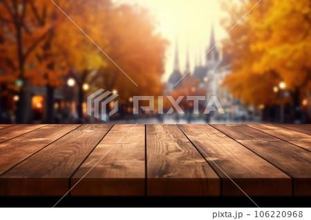 The empty wooden table top with blur background of European street in autumn. Exuberant. The empty wooden table top with blur background of European street in autumn. Exuberant. 106220968