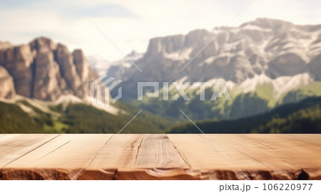 The empty wooden brown table top with blur background of dolomite mountain. Exuberant. 106220977