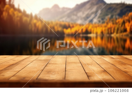 The empty wooden table top with blur background of lake and mountain in autumn. Exuberant. The empty wooden table top with blur background of lake and mountain in autumn. Exuberant. 106221008
