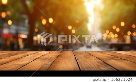 The empty wooden table top with blur background of outdoor cafe at the street. Exuberant. 106221024