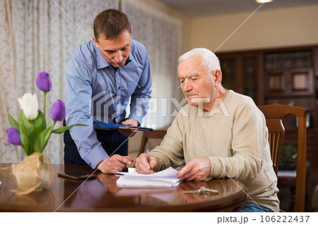 Man filling out papers 106222437