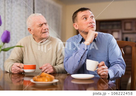 Man and his adult son drinking tea 106222458
