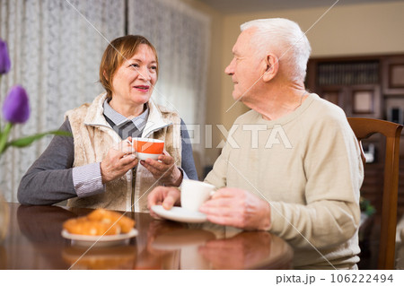 Elderly man and woman enjoying conversation 106222494