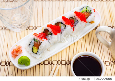 Urumaki roll with salmon avocado pepino and tobiko 106222600