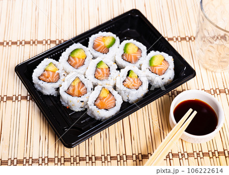 Juicy california roll on plate with chopsticks, wasabi and soy sauce Juicy california roll on plate with chopsticks, wasabi and soy sauce 106222614