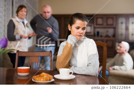 Offended woman sitting by table 106222664