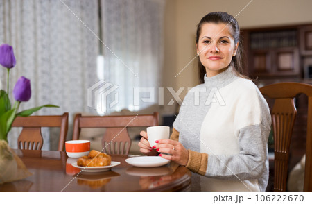 Woman drinking tea at living room 106222670