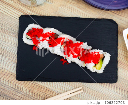 Urumaki roll with salmon avocado pepino and tobiko 106222708