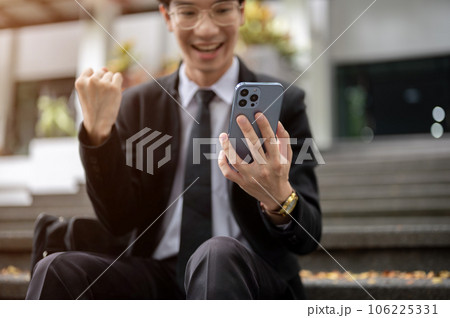Cropped image, A cheerful Asian businessman receiving good news on the phone, got a new job 106225331
