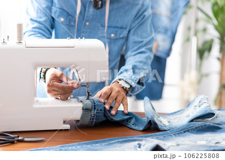 tailor working with jeans. tailor working with jeans. 106225808