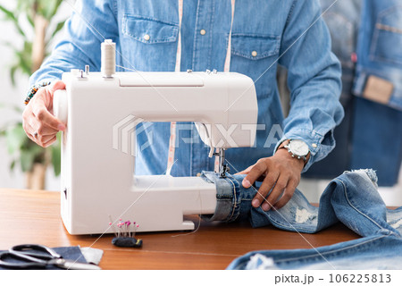 tailor working with jeans. 106225813