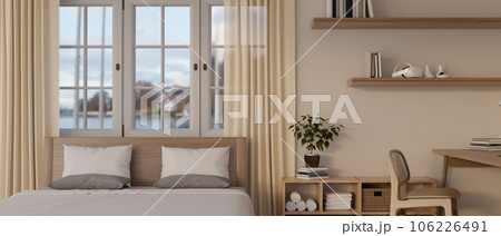 A Scandinavian minimalist bedroom interior with a comfy bed against the window with sheer curtains 106226491