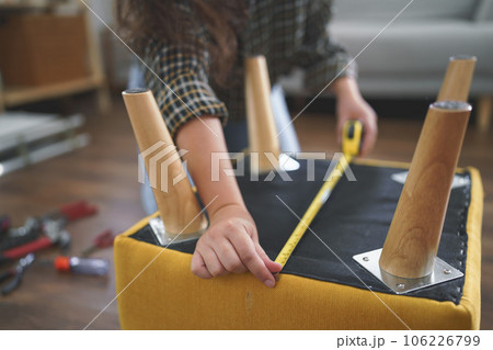 Women use measure tape equipment to measuring size of chair while assembling furniture for new home Women use measure tape equipment to measuring size of chair while assembling furniture for new home 106226799
