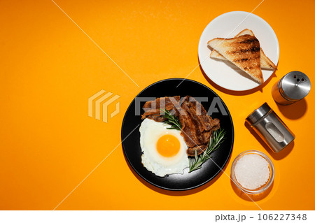 Tasty breakfast and delicious meat food concept - fried bacon 106227348
