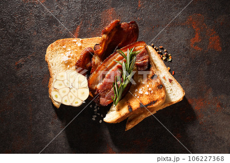 Tasty breakfast and delicious meat food concept - fried bacon Tasty breakfast and delicious meat food concept - fried bacon 106227368