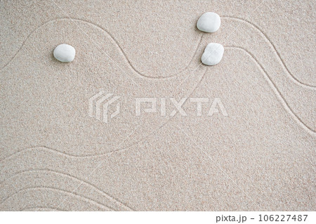 Japanese Zen Garden with Pebble with Line on Sand.mini Stone on Beach backgrond Top View and nobody.Ciircle Rock Balance Japan on nature.Simplicity Purity life.Relax Aromatherapy Spa and Yoga.Buddhism Japanese Zen Garden with Pebble with Line on Sand.mini Stone on Beach backgrond Top View and nobody.Ciircle Rock Balance Japan on nature.Simplicity Purity life.Relax Aromatherapy Spa and Yoga.Buddhism 106227487