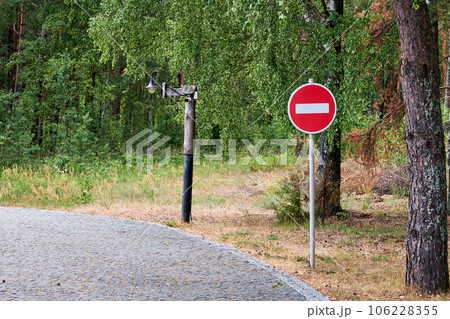 Red road sign Entry is prohibited against the background of the forest Red road sign Entry is prohibited against the background of the forest 106228355