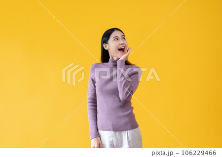 A beautiful Asian woman is looking upwards with a happy face. surprised, amazed, good news 106229466
