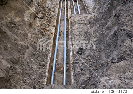 Excavated pit with plastic plumbing sewage pipes for repair and installation Excavated pit with plastic plumbing sewage pipes for repair and installation 106231789