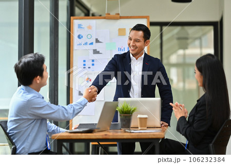 Confident male team leader shaking hands after successful meeting. Teamwork, success and support 106232384