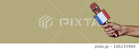holds a mic patterned with the french flag, banner holds a mic patterned with the french flag, banner 106235960