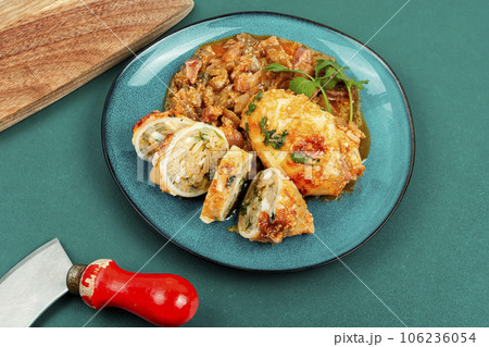 Sliced baked squid stuffed with rice. 106236054