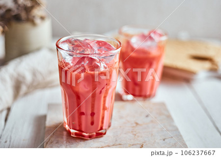 Thai style iced pink milk.Cold sweet drink Red Grenadien Sugar Syrup mix with milk and iced cube in glass 106237667