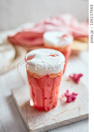 Thai style iced pink milk.Cold sweet drink Red Grenadien Sugar Syrup mix with milk and iced cube in glass 106237668
