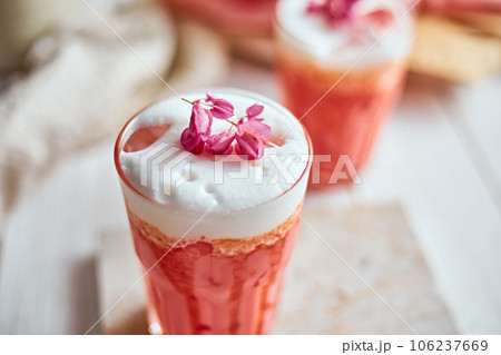 Thai style iced pink milk.Cold sweet drink Red Grenadien Sugar Syrup mix with milk and iced cube in glass Thai style iced pink milk.Cold sweet drink Red Grenadien Sugar Syrup mix with milk and iced cube in glass 106237669