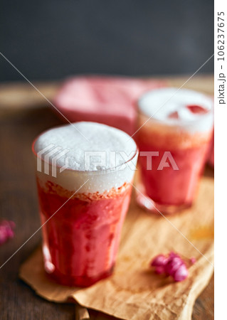 Thai style iced pink milk.Cold sweet drink Red Grenadien Sugar Syrup mix with milk and iced cube in glass Thai style iced pink milk.Cold sweet drink Red Grenadien Sugar Syrup mix with milk and iced cube in glass 106237675