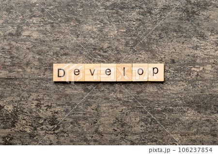 Develop word written on wood block. Develop text on cement table for your desing, concept 106237854