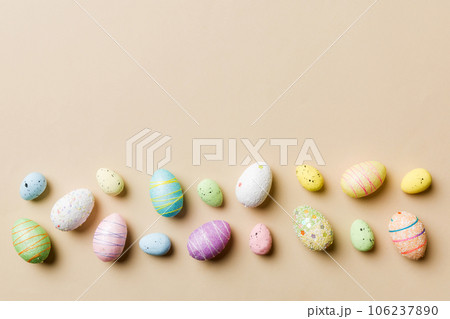 Happy Easter concept. Preparation for holiday. Easter eggs on colored background. flat lay top view copy space banner Happy Easter concept. Preparation for holiday. Easter eggs on colored background. flat lay top view copy space banner 106237890