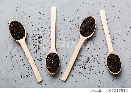 quinoa seeds in bowl and spoon on colored background. Healthy kinwa in small bowl. Healthy superfood 106237939