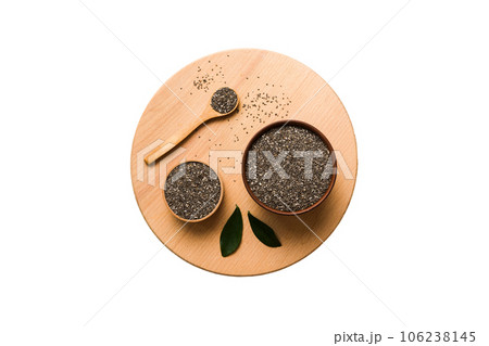 Chia seeds in bowl and spoon on colored background. Healthy Salvia hispanica in small bowl. Healthy superfood Chia seeds in bowl and spoon on colored background. Healthy Salvia hispanica in small bowl. Healthy superfood 106238145