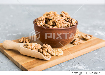 Fresh healthy walnuts in bowl on colored table background. Top view Healthy eating bertholletia concept. Super foods Fresh healthy walnuts in bowl on colored table background. Top view Healthy eating bertholletia concept. Super foods 106238148