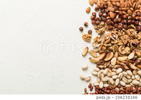 different nuts frame background. Close up, top view, flat lay with vopy space. Walnut, pistachios, almonds, hazelnuts and cashews different nuts frame background. Close up, top view, flat lay with vopy space. Walnut, pistachios, almonds, hazelnuts and cashews 106238166