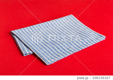 top view with blue kitchen napkin isolated on table background. Folded cloth for mockup with copy space, Flat lay. Minimal style top view with blue kitchen napkin isolated on table background. Folded cloth for mockup with copy space, Flat lay. Minimal style 106238167