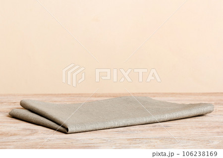 top view with gray kitchen napkin isolated on table background. Folded cloth for mockup with copy space, Flat lay. Minimal style top view with gray kitchen napkin isolated on table background. Folded cloth for mockup with copy space, Flat lay. Minimal style 106238169