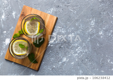 Healthy breakfast or morning with chia seeds lemon and mint on table background, vegetarian food, diet and health concept. Chia pudding with lemon and mint Healthy breakfast or morning with chia seeds lemon and mint on table background, vegetarian food, diet and health concept. Chia pudding with lemon and mint 106238412