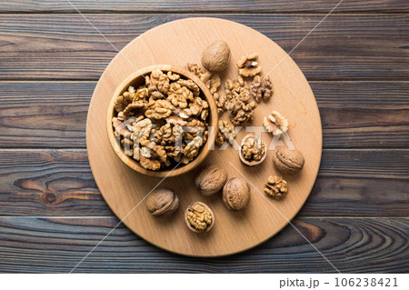 Fresh healthy walnuts in bowl on colored table background. Top view Healthy eating bertholletia concept. Super foods Fresh healthy walnuts in bowl on colored table background. Top view Healthy eating bertholletia concept. Super foods 106238421