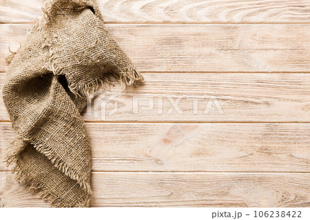 Old burlap fabric napkin, sackcloth on table background. top view with copy space Old burlap fabric napkin, sackcloth on table background. top view with copy space 106238422