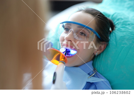 Patient visiting dentist for regular check-up and filling teeth closeup 106238602