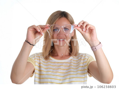 Portre young woman with poor eyesight holds glasses in hands 106238603