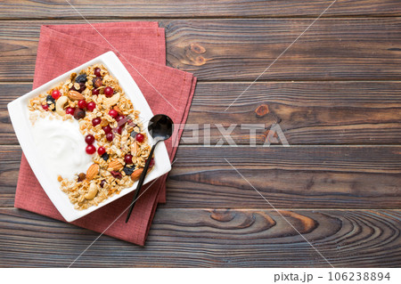 Healthy breakfast food with granola, yogurt, fruits and nuts. Dessert parfait with dried fruits for breakfast Healthy breakfast food with granola, yogurt, fruits and nuts. Dessert parfait with dried fruits for breakfast 106238894